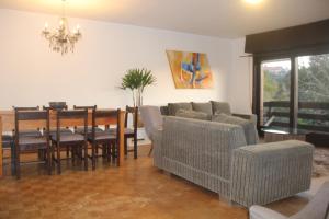 a living room with a table and chairs and a dining room at Mais Incrível Localização de Gramado in Gramado