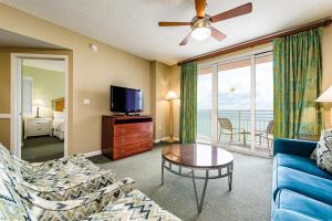 a living room with a couch and a tv at Unit 2427 Ocean Walk - 2 Bedroom Ocean Front in Daytona Beach