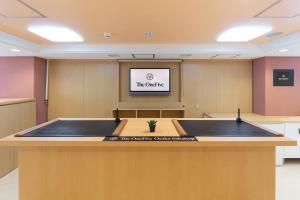 a conference room with a podium in the middle at The OneFive Osaka Sakaisuji in Osaka