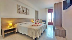 Postel nebo postele na pokoji v ubytování Hotel Residence Costa Azzurra