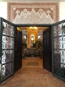 an entrance to a building with an open door at Riad Salt River in Martil