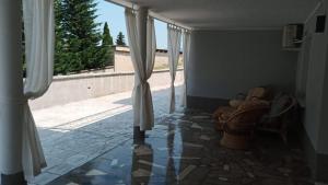 a living room with a couch and a window at Apartma Pata, Koper - Čežarji in Čežarji