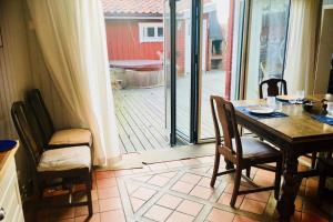 a dining room with a table and chairs and a sliding glass door at House for 7-8 central in Sandhamn, access to dock in Sandhamn