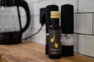 a bottle of olive oil sitting on a wooden table at Marilias Luxury Studio Apartment in Kissamos +6 photos