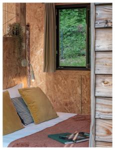 a bedroom with a bed with a window and a window at Volvic Organic Resort in Volvic