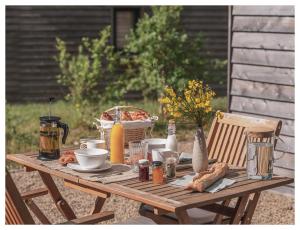 a picnic table with food and bread on it at Volvic Organic Resort in Volvic +28 photos