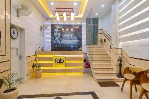a lobby with stairs and a job sign on the door at FabHotel Ruklo in Patna