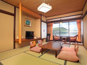 a living room with a table and chairs at Kimimachisou in Chino