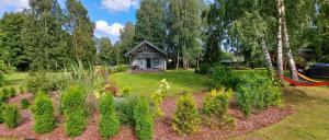 a garden with a hammock in a park at Brīvdienu māja ar Saunu in Saulkrasti