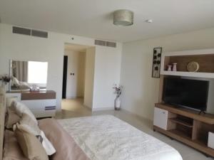 a bedroom with a large bed and a flat screen tv at 2 BEDROOM in PALM JUMEIRAH CRESCENT BALQIS RESIDENCE DIRECT BEACH ACCESS in Dubai