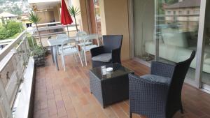 a balcony with chairs and a table on a balcony at Golfo d'Oro in Ascona