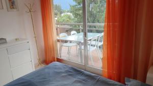 a room with a table and chairs and a window at Golfo d'Oro in Ascona