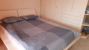 a bed with two pillows in a small room at Golfo d'Oro in Ascona