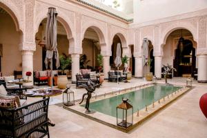a pool in a building with a statue in the middle at Riad Fes - Relais & Châteaux in Fez