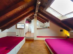 a attic bedroom with two beds and a skylight at La vita è bella - Noli in Noli