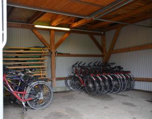 a bunch of bikes parked in a garage at Hotel Bergwirt in Herrieden
