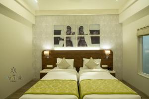 Cama ou camas em um quarto em The Avatar Hotel & Convention
