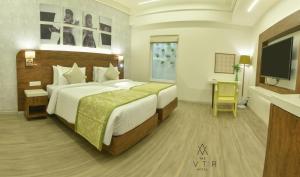 Cama ou camas em um quarto em The Avatar Hotel & Convention