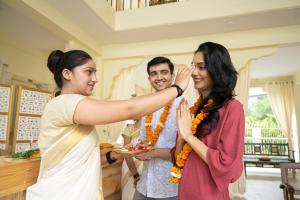 a woman is touching the ear of a woman at Maharishi Ayurveda-Boutique Wellness Retreat in Rishīkesh