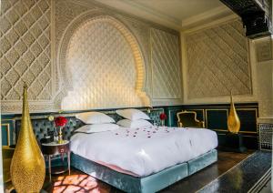 a bedroom with a large white bed in a room at Riad Fes - Relais & Châteaux in Fès
