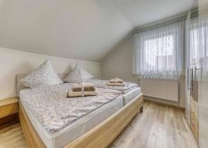 a large bed in a room with a window at Ferienchalet zum Lusen in Sankt Oswald