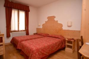 Postel nebo postele na pokoji v ubytování Albergo Da Gildo