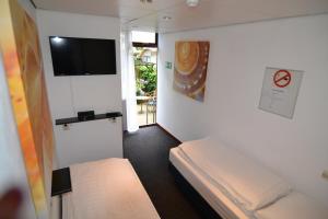 Postel nebo postele na pokoji v ubytování Hotel Bienvenue