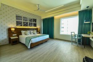 Cama ou camas em um quarto em The Avatar Hotel & Convention