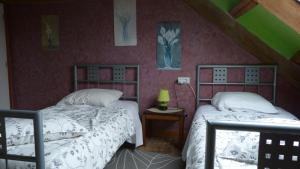 Un dormitorio con dos camas en un ático. en chambres d'hôtes proche saint Malo et mont saint Michel, en La Boussac