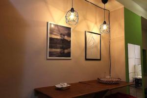 ein Esszimmer mit 2 Leuchten und einem Tisch in der Unterkunft Vado al teatro monolocale in centro per 2 in Ancona