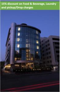 a large glass building with its lights on at The Mirador Andheri East in Mumbai