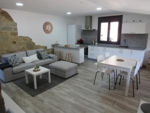 a living room with a couch and a table at Casa As Salcedas in Meis