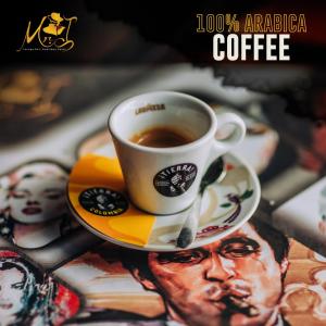 a cup of coffee sitting on top of a plate at Mr.I Boutique Hotel & Bar in Ohrid