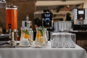 a group of glasses on a counter with a drink at Leśny Apartament Nad Zalewem in Kielce