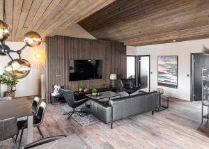a living room with a couch and a table at Pier Apartments in Vestmannaeyjar