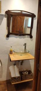 a bathroom with a sink and a mirror at La Morada de Higuera in Higuera de la Sierra +27 photos