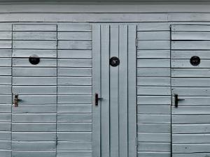 a pair of metal garage doors on a building at Camping Zvejnieksēta in Pāvilosta