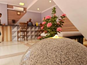 a room with a vase of flowers and a staircase at Royale Suites by Arc Royal Luxury Apts in Anse Royale