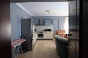 a kitchen with a black refrigerator and a table at Kriopigi Apartments in Kriopigi