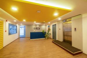 an office with a yellow ceiling in a hallway at Olive Magrath - By Embassy Group in Bangalore