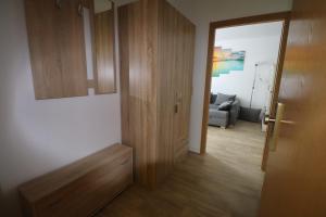 a room with a wooden door and a living room at Gästewohnung "ALTE SPINNEREI" in Kirchberg