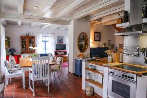a kitchen with a table and a dining room at Landhaus einer Malerin in Poseritz