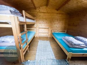 a bunk bed room with two bunk beds in a cabin at Camping Zvejnieksēta in Pāvilosta