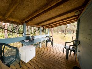 a screened porch with a table and two chairs at Camping Zvejnieksēta in Pāvilosta
