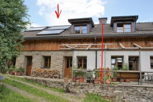 a house with solar panels on the roof at Rustikale und grosszügige Ferienwohnung in Kašperské Hory