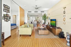 a living room with a couch and a tv at 20 S at the Marina in Airlie Beach