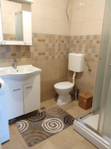 a bathroom with a toilet and a sink at Guest House Cvoro in Herceg-Novi +35 photos