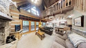 a living room with a couch and a fireplace at Streamsong Secluded Creek View Cabin in Hatchertown