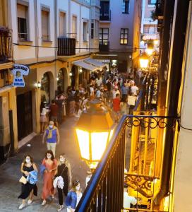 a crowd of people walking down a street at night at Los Balcones de Laurel in Logroño