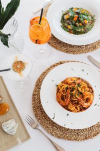 a table with plates of food and glasses of orange juice at Hotel Ritual de Terra & SPA in Jávea